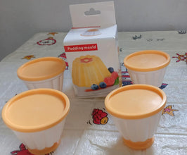 Set of pudding molds with covers for homemade desserts.